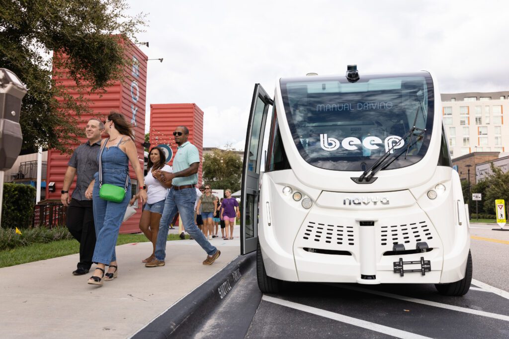 Beep Autonomous Shuttle dropping off two couples at Boxi Park at Lake Nona Town Center